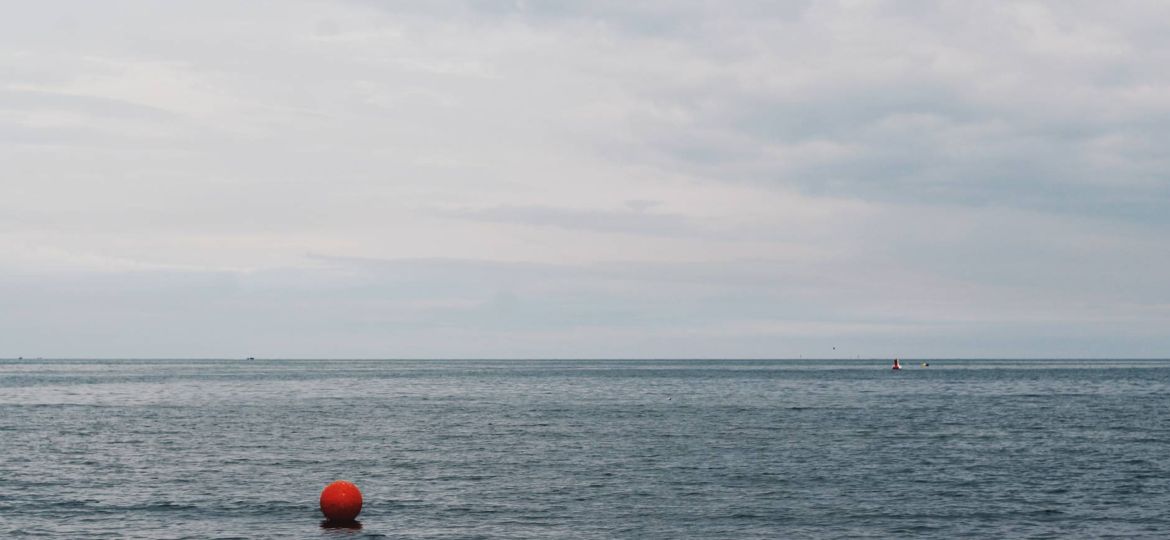 red buoy floating on body of water